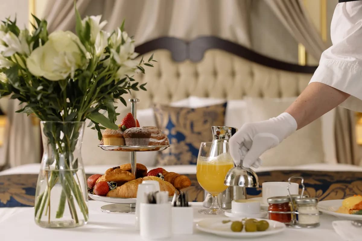 BookNoFees example image: Breakfast table with pastries, flowers and a glass of orange juice