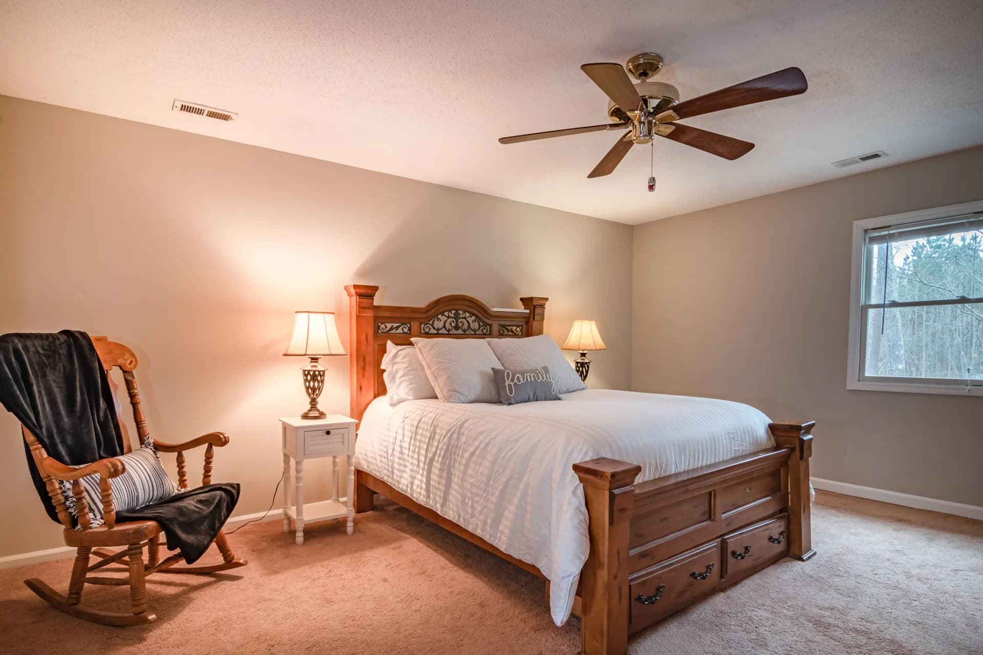 BookNoFees example image: Bedroom with a large wooden bed and a rocking chair