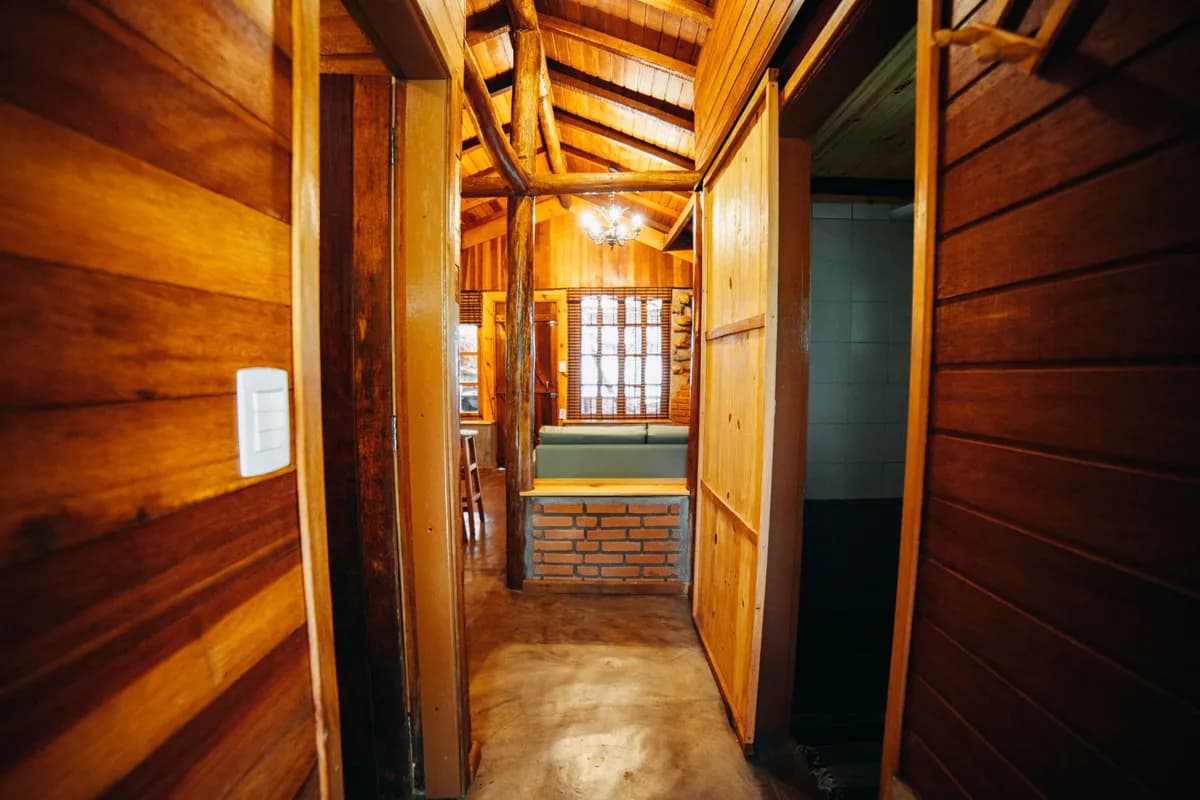 BookNoFees example image: Narrow corridor with wooden walls and a seat by the window