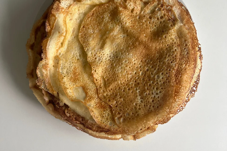BookNoFees: Example photo: Thin golden pancakes on a white plate