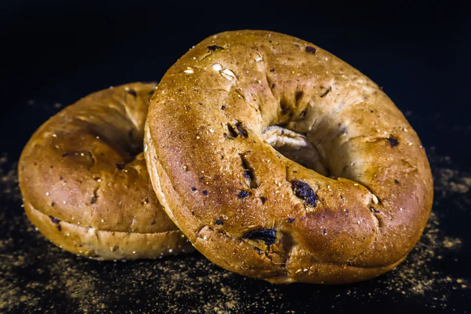 BookNoFees: Example photo: Two golden-brown bagels on a dark background